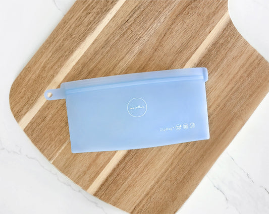 snack zipbag on a wooden cutting board, silicone reusable and sustainable bag