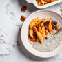 Chia pudding with caramelized apples, cinnamon, pecan and cranberries, top view. Winter vegan breakfast recipe.