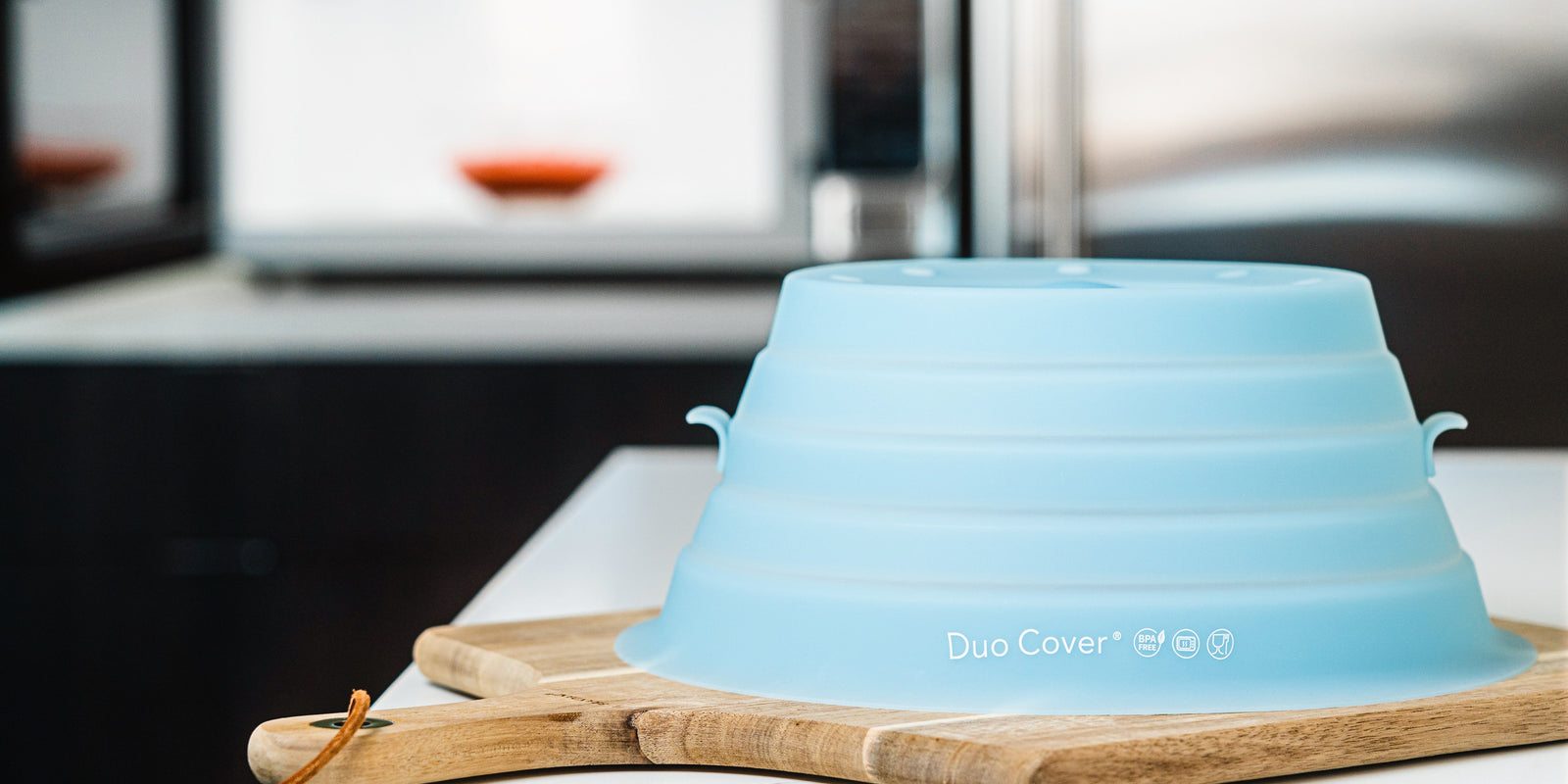 Duo Cover, silicone eco-friendly microwave cover sitting on top of a kitchen counter