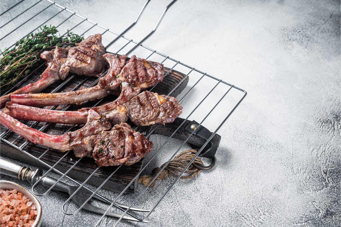 Barbecue grilled lamb meat chop on a grill, mutton rib cutlet. White background. Top view. Copy space.