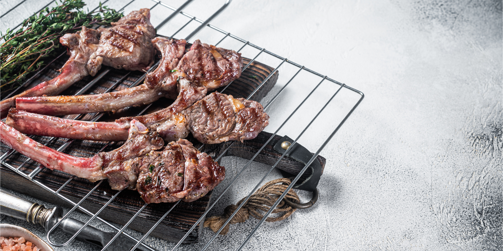 Barbecue grilled lamb meat chop on a grill, mutton rib cutlet. White background. Top view. Copy space.