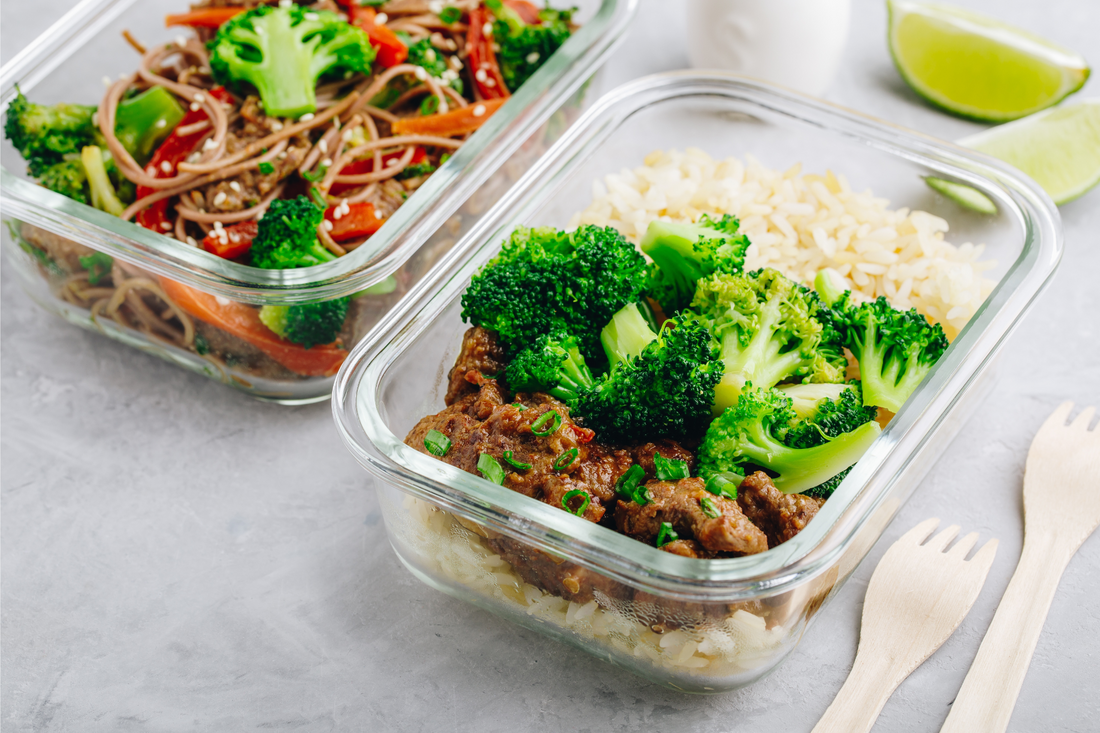 Beef broccoli stir fry meal prep lunch box container on gray stone background, easy recipe for busy weekdays.