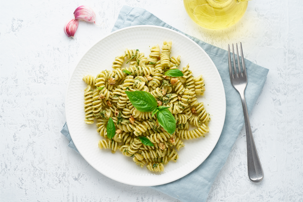  fusilli spaghetti pasta with pesto and parmesan cheese. Italian sauce with basil, garlic, walnuts.