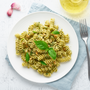  fusilli spaghetti pasta with pesto and parmesan cheese. Italian sauce with basil, garlic, walnuts.