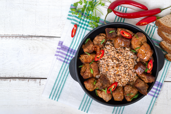 Roast pork with buckwheat. A dish in a slow cooker. Top view.