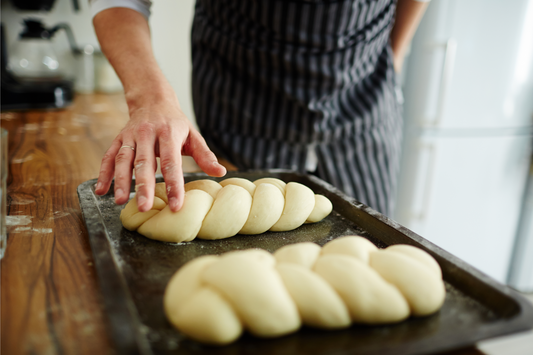 Pastry-chef making buns from dough. Making bread from scratch. Homemade bread.