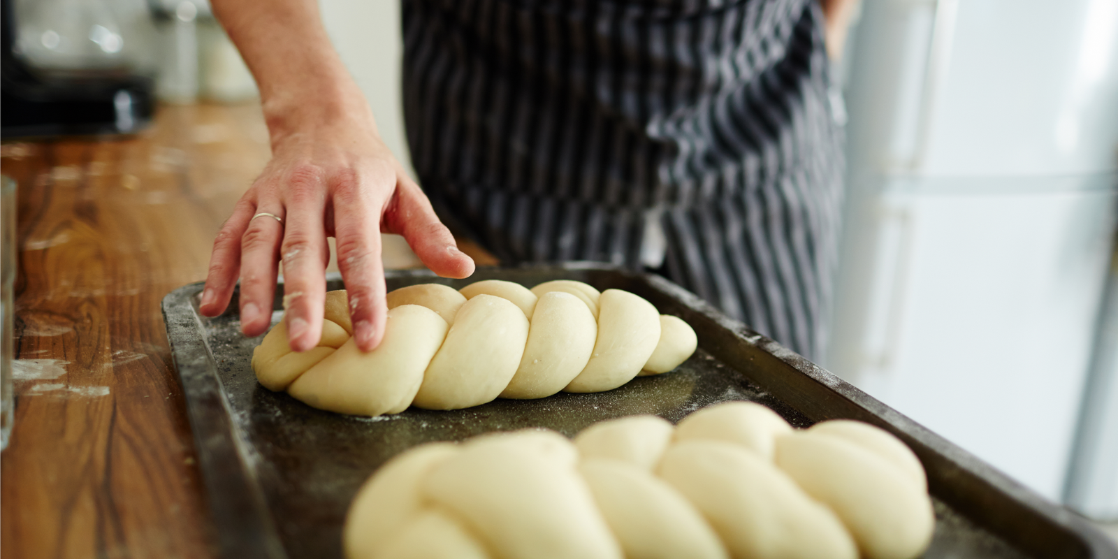 Pastry-chef making buns from dough. Making bread from scratch. Homemade bread.