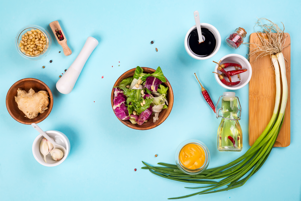 Cooking - dark brown salad dressing and recipe ingredients balsamic vinegar, honey, olive oil, mustard, garlic, salt . Layout captured from above top view, flat lay .