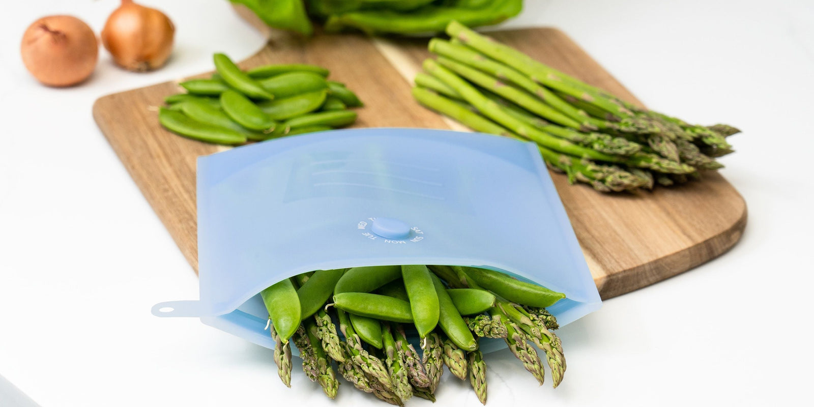 meal prepping food, storing it in silicone reusable bags. sustainable meal-prepping