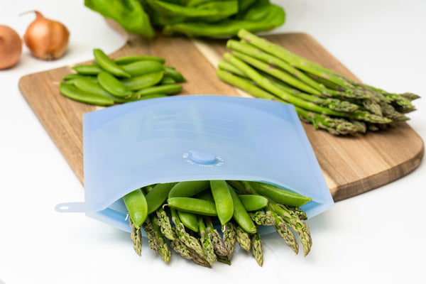 Zipbag sitting on the counter being used to store vegetables. Reusable silicone bag