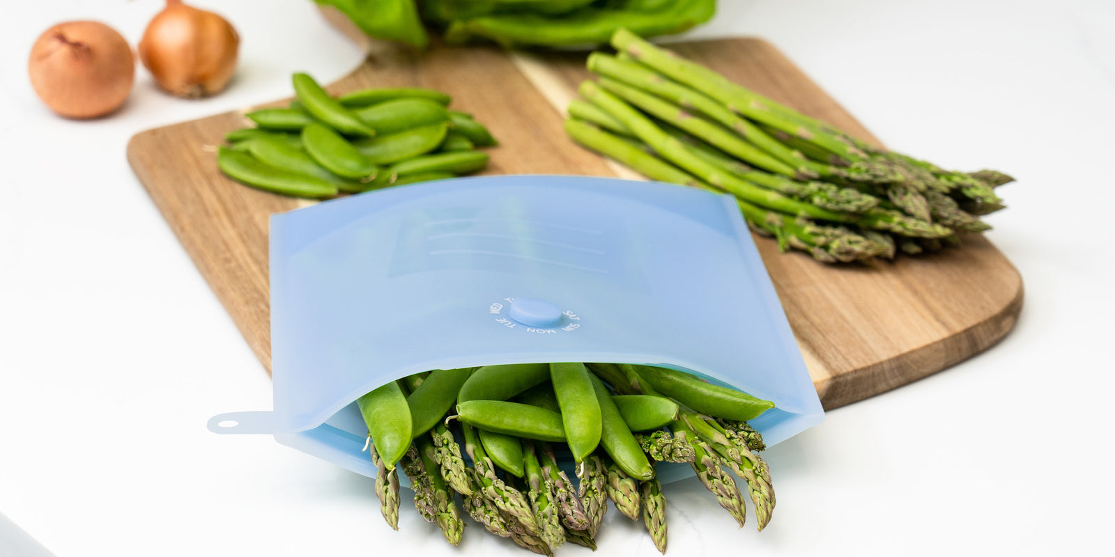 Zipbag sitting on the counter being used to store vegetables. Reusable silicone bag