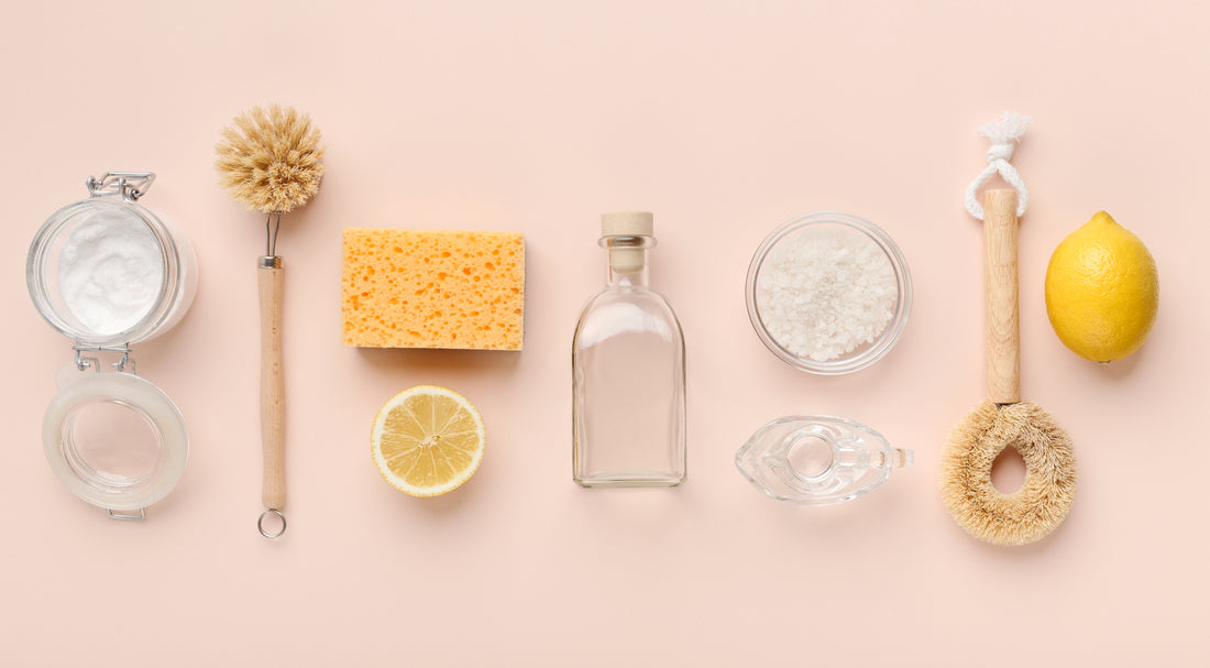 Flat lay composition with eco-friendly natural cleaners. Baking soda, salt, lemon, bamboo brushes on pink background, panorama