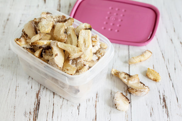  Food for the winter. Frozen vegetables. Container with frozen mushrooms.