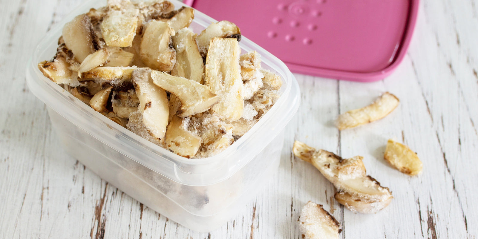  Food for the winter. Frozen vegetables. Container with frozen mushrooms.