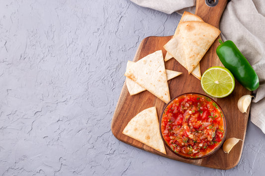 Salsa Asada sauce with tortilla chips and lime, Tex-Mex cuisine, top view, copy space