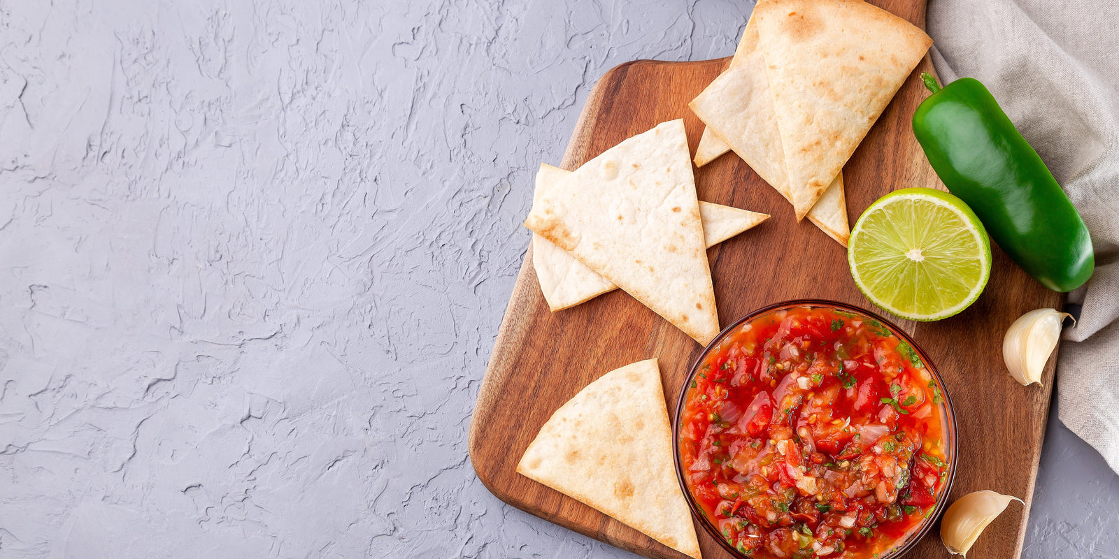 Salsa Asada sauce with tortilla chips and lime, Tex-Mex cuisine, top view, copy space