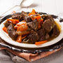 Stew with beef and carrots in a plate, horizontal