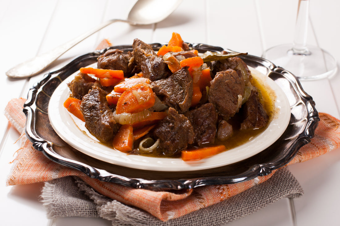 Stew with beef and carrots in a plate, horizontal