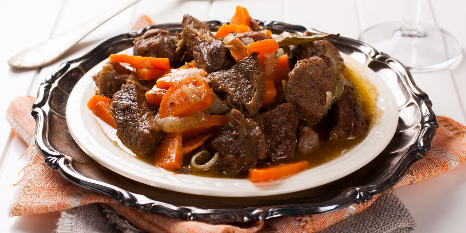 Stew with beef and carrots in a plate, horizontal